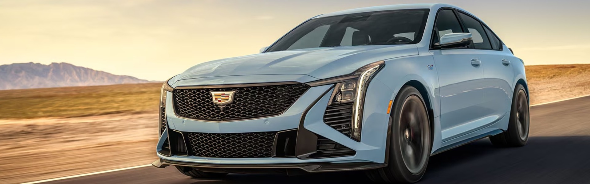 2025 Cadillac CT5-V luxury midsize sedan driving on a road.
